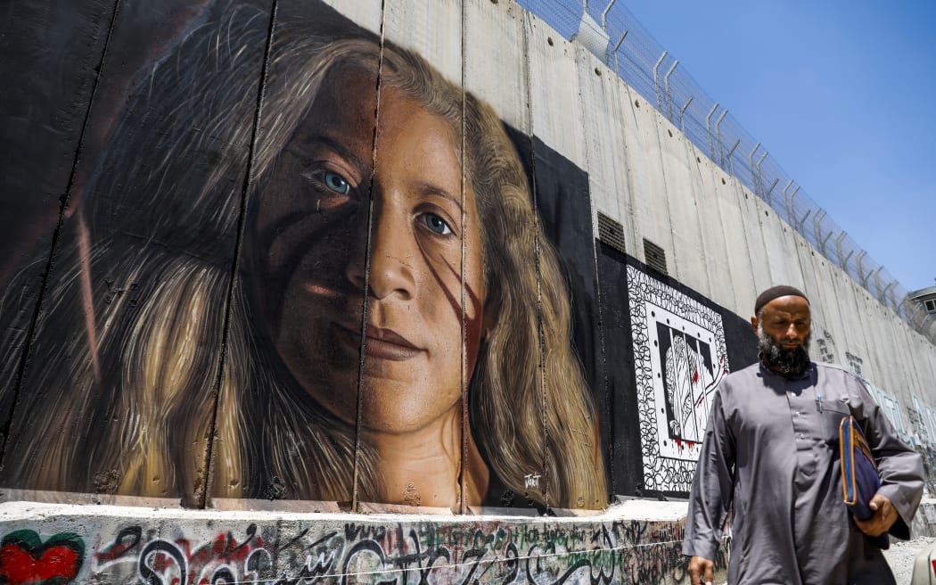 A mural on Israel's controversial separation barrier in the West Bank city of Bethlehem painted drawn by Italian artist Jorit Agoch.