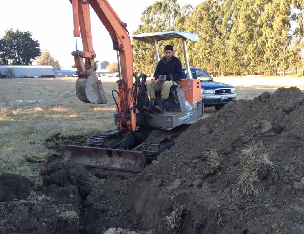 Josh Olykan burying the sheep that were attacked by dogs on his parents' property.