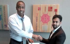 The founder of Instacharge, Douglas Stewart, left, meets with businessman Gaurangbhai Patel in Fiji last week