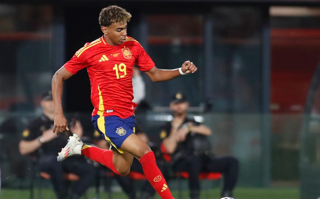 Spain's forward Lamine Yamal runs with the ball