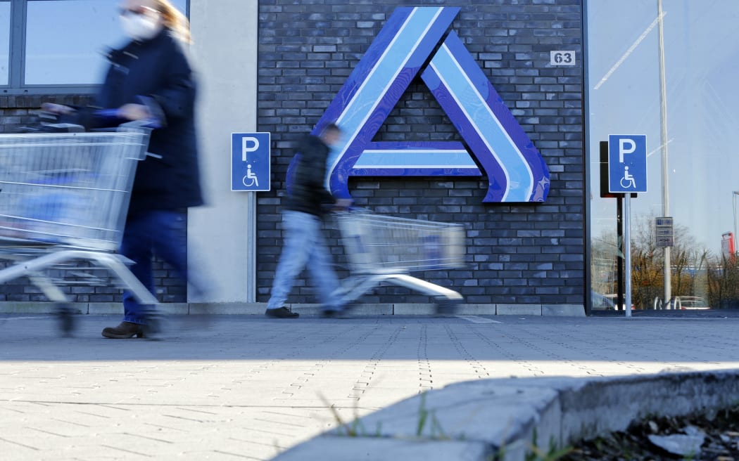 Customers are seen with shopping carts at an Aldi supermarket in Luenen, western Germany, on 5 March, 2021.