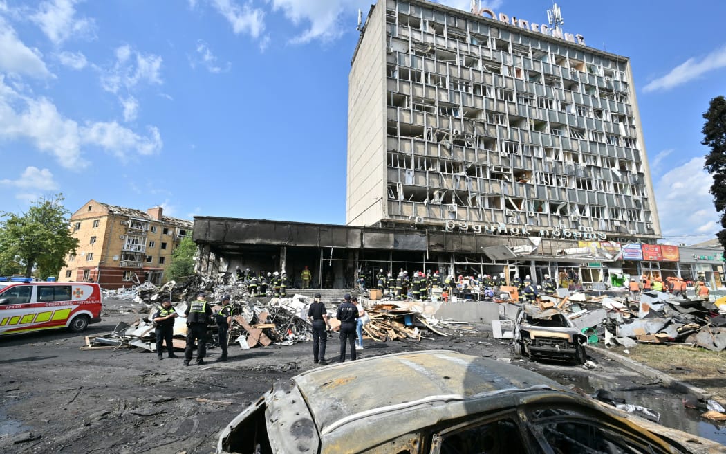 Firefighters inspect a damaged building following a Russian airstrike in the city of Vinnytsia, west-central Ukraine on July 14, 2022.