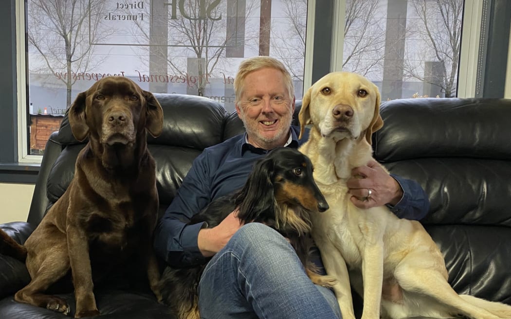 Owen Haring doesn’t think it’s justifiable to have to pay that much to have chocolate labrador Holly, dachshund Frankie, and golden labrador Harry at his home. Photo: Max Frethey.