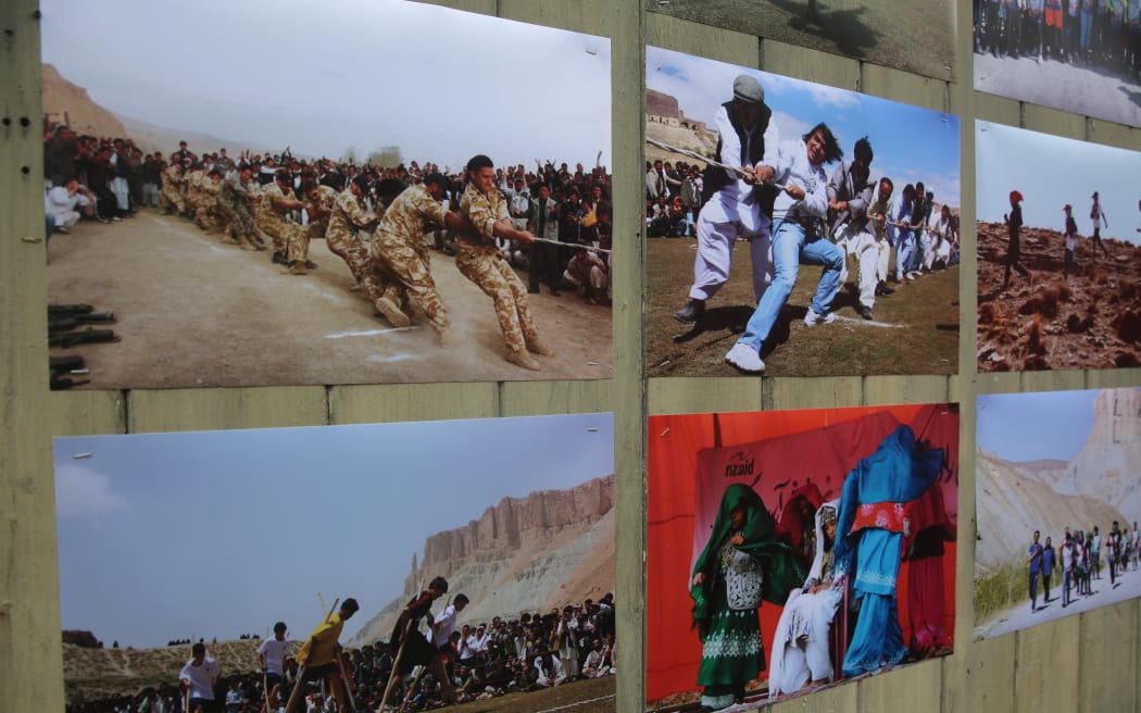 A photo at the Aotearoa Afghanistan Marathon exhibition shows New Zealand troops putting their guns aside and joining in a game of tug of war with Bamyan locals.