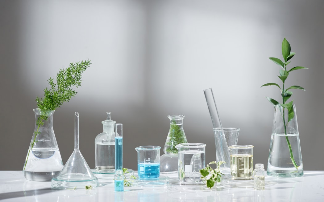 laboratory experiment and research with leaf, oil and ingredient extract for natural beauty and organic skincare product the blank bottle for label ,bio science concept. alternative medicine. spa.