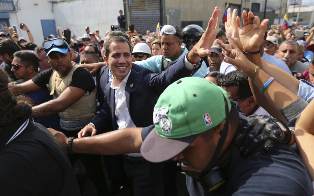 Venezuela's self-proclaimed president Juan Guaido greets supporters in Caracas, Venezuela, Tuesday, April 30, 2019.