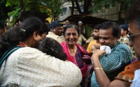 Relatives grieve outside a mortuary where the bodies of stampede victims were taken