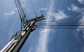 Power lines against a bright blue sky.