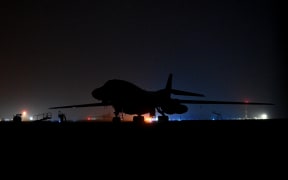 The silhouette US Air Force B-1 Lancer bomber at RAF Fairford in south west England shortly after sunrise on March 7, 2026. Britain's Prime Minister Keir Starmer has given approval for Washington to use the bases of Diego Garcia in the Indian Ocean and RAF Fairford in south-west England to bomb Iranian missile sites, after several Gulf countries were targeted by Iranian retaliations. (Photo by JUSTIN TALLIS / AFP)