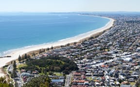 The panoramic view of Maunt Maunganui resort town from the top of Mount Maunganui volcano (Tauranga, New Zealand).