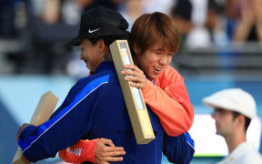 HORIGOME Yuto of Japan (R), gold, and HUSTON Nyjah of the U.S., bronze, hug each other after a medal ceremony of the men's skateboarding street final in the Paris Olympics at the Place de la Concorde 3 in Paris, France, on July 29, 2024. ( The Yomiuri Shimbun ) (Photo by Takuya Matsumoto / Yomiuri / The Yomiuri Shimbun via AFP)
