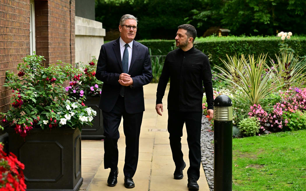 Britain's Prime Minister Keir Starmer (L) walks with Ukraine's President Volodymyr Zelensky in the garden of 10 Downing Street in central London, on 14 August, 2025.