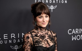 Dakota Johnson attends a charity event with the Kering Foundation in New York.