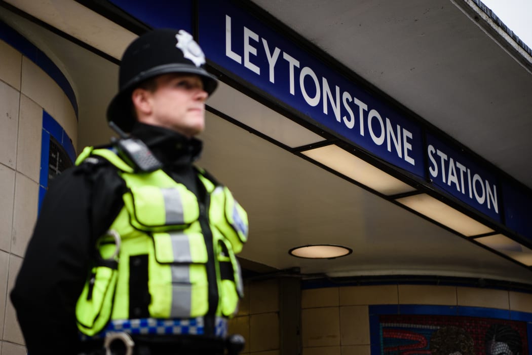 A policeman stands guard at Leytonstone Station