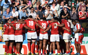 The Tongan team huddle together following their Rugby World Cup defeat to Argentina.