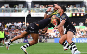 Valentine Holmes of Australia is tackled during the 2023 Pacific Championship final between Australia Kangaroos and New Zealand Kiwis.