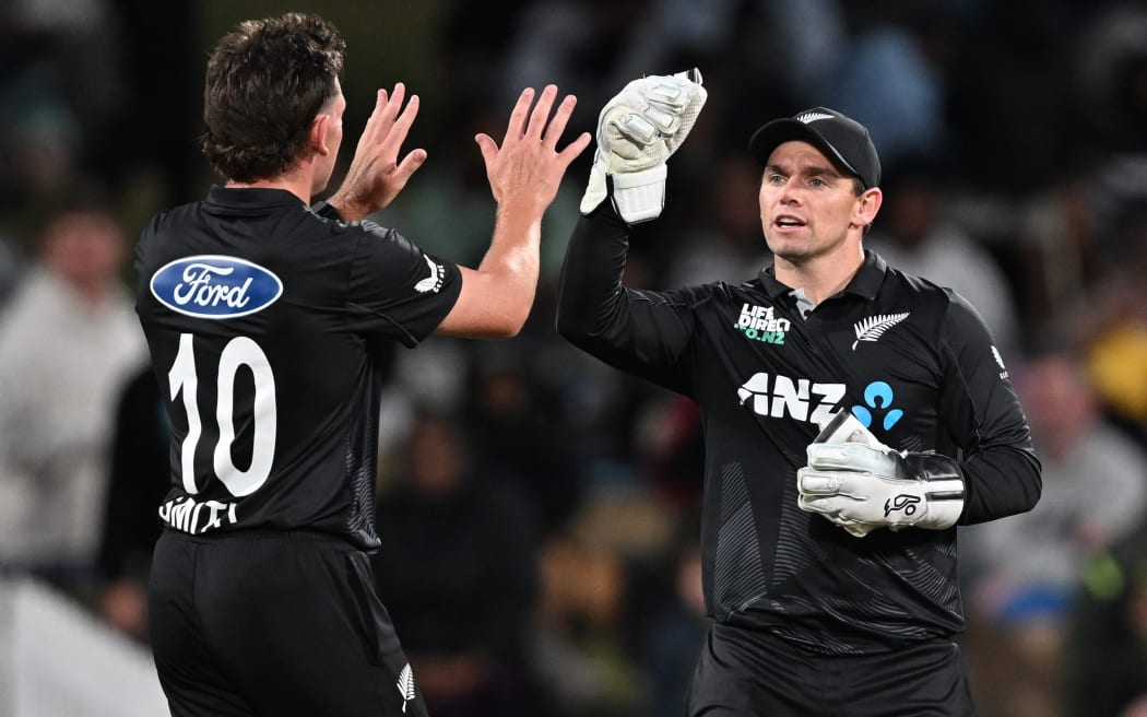 New Zealand bowler Nathan Smith celebrates with team mate Tom Latham