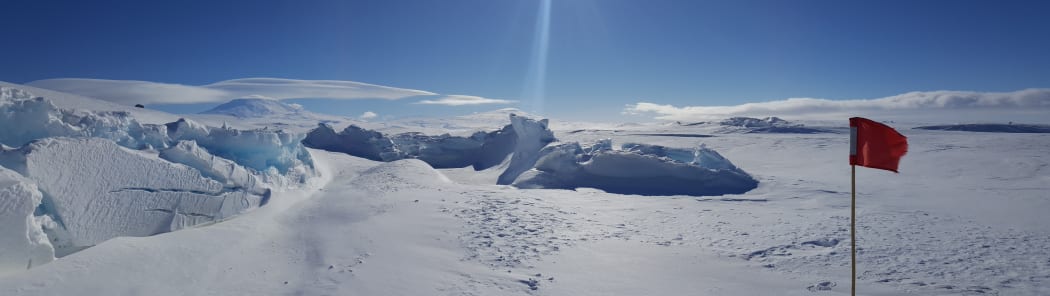 The pressure ridges in front of Scott Base form as the sea ice is pushed against the shore by the movement of the ice shelf behind. Mt Erebus in the background.