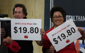 Members of Living Wage group with signs showing the 2016 living wage rate.
