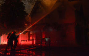 Firefighters tackle the blaze at Christchurch's 152-year-old Risingholme Community Centre.
