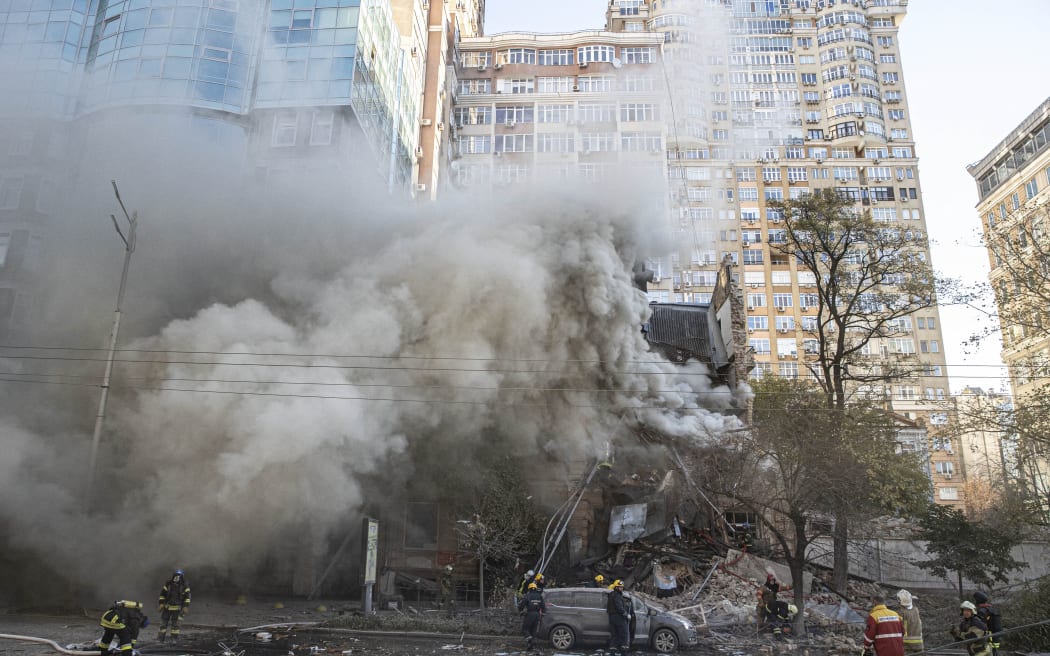 KYIV, UKRAINE - OCTOBER 17: Firefighters conduct work in a destroyed building after Russian attacks in Kyiv, Ukraine on October 17, 2022. It was reported that two separate explosions occurred in Kyiv due to the attacks carried out by the Russian forces in the early hours of the morning. Metin Aktas / Anadolu Agency (Photo by Metin Aktas / ANADOLU AGENCY / Anadolu Agency via AFP)
