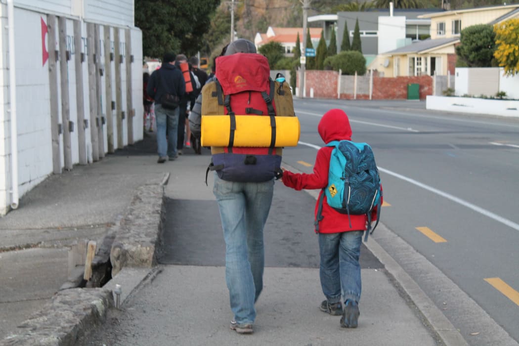 A photo of a mother and son holding hands. As the walk continued, some of the younger children lagged behind and parents observed that, in a genuine refugee situation, this could lead to families getting separated.