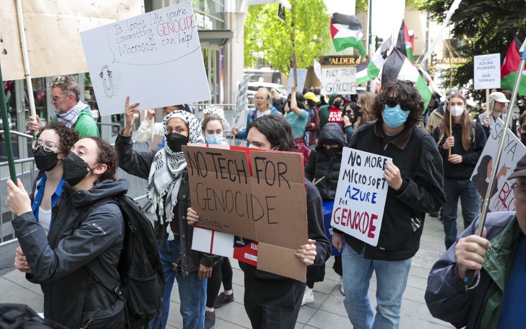 Pro-Palestinian demonstrators hold signs as they protest outside the Microsoft Build conference at the Seattle Convention Center in Seattle, Washington on 19 May, 2025.