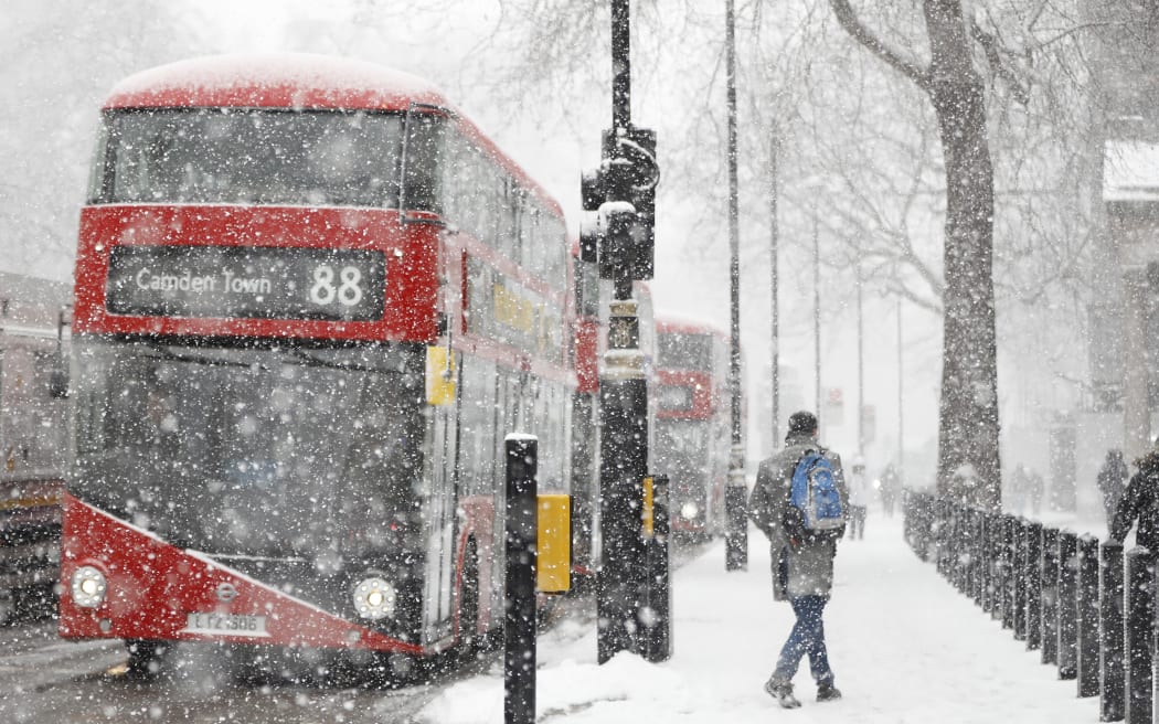 A blizzard hits central London as temperatures remain below freezing.