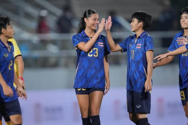 Thai-New Zealander Natalie Olson high-fives another player at a game for the Thailand women's football team for the Southeast Asian Games.