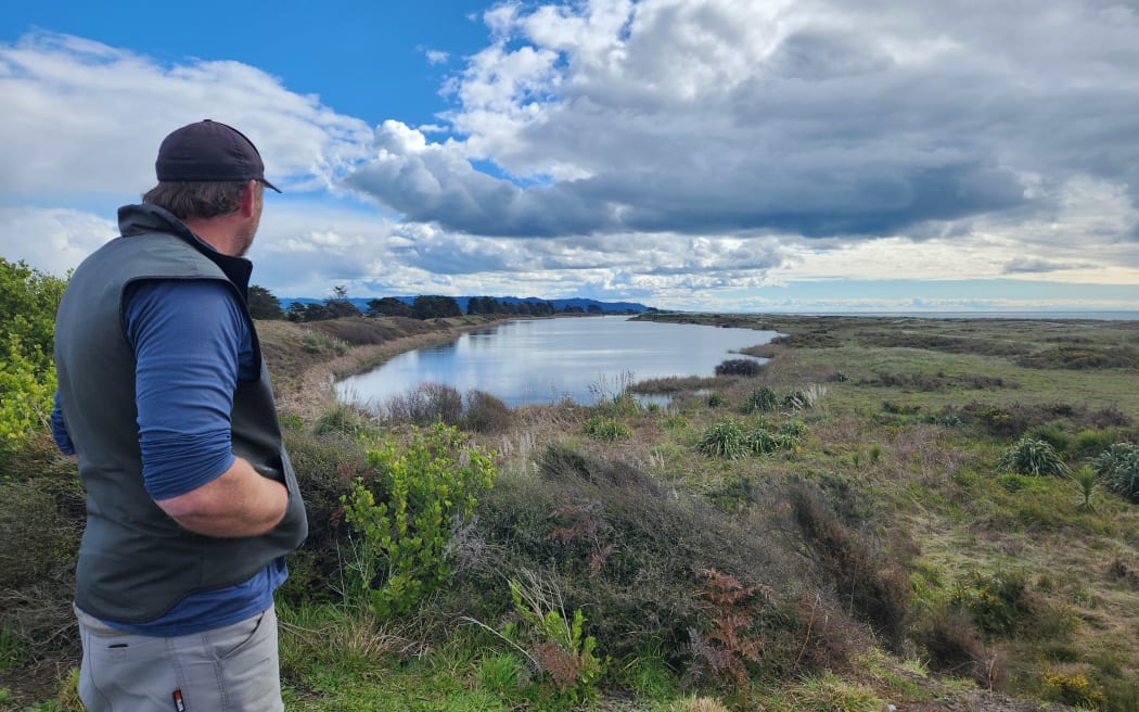 Ben looks out over the wildlife reserve where he has been trapping for more than a year. The lagoon is in the distance.