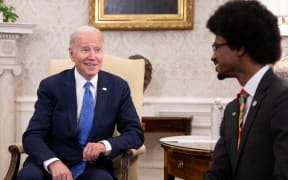 US President Joe Biden speaks with  Tennessee Democrat expelled from the Tennessee state legislature over gun control protest Justin Pearson (R) during a meeting to discuss efforts to ban assault weapons in the Oval Office at the White House in Washington, DC, on April 24, 2023. (Photo by Jim WATSON / AFP)