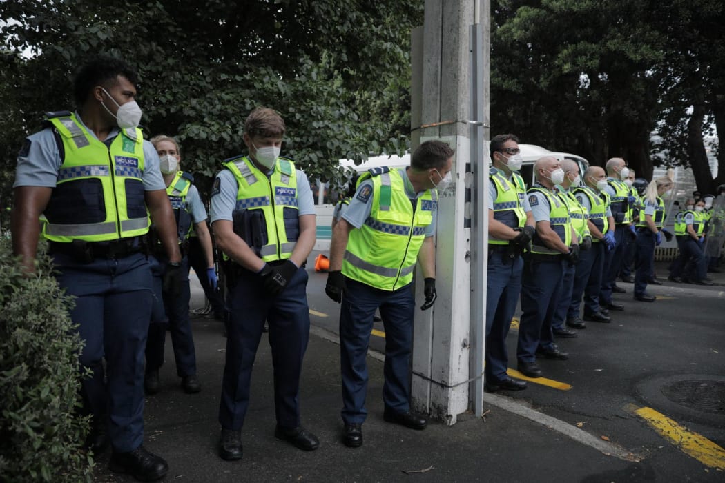 Police undertake an early morning operation to restore order and access to the area around Parliament.