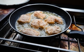 Snapper bites frying in pan.