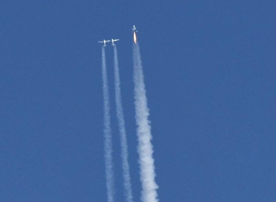 Virgin Galactic's VSS Unity launches for a suborbital test flight on December 13, 2018, in Mojave, California. - Virgin Galactic marked a major milestone on Thursday as its spaceship made it to a peak height, or apogee, of(82.7 kilometers),