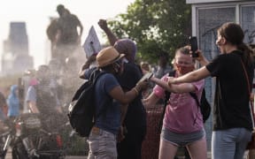 MINNEAPOLIS, MN - MAY 27: Protesters are shot with pepper spray as they confront police outside the Third Police Precinct on May 27, 2020 in Minneapolis, Minnesota.