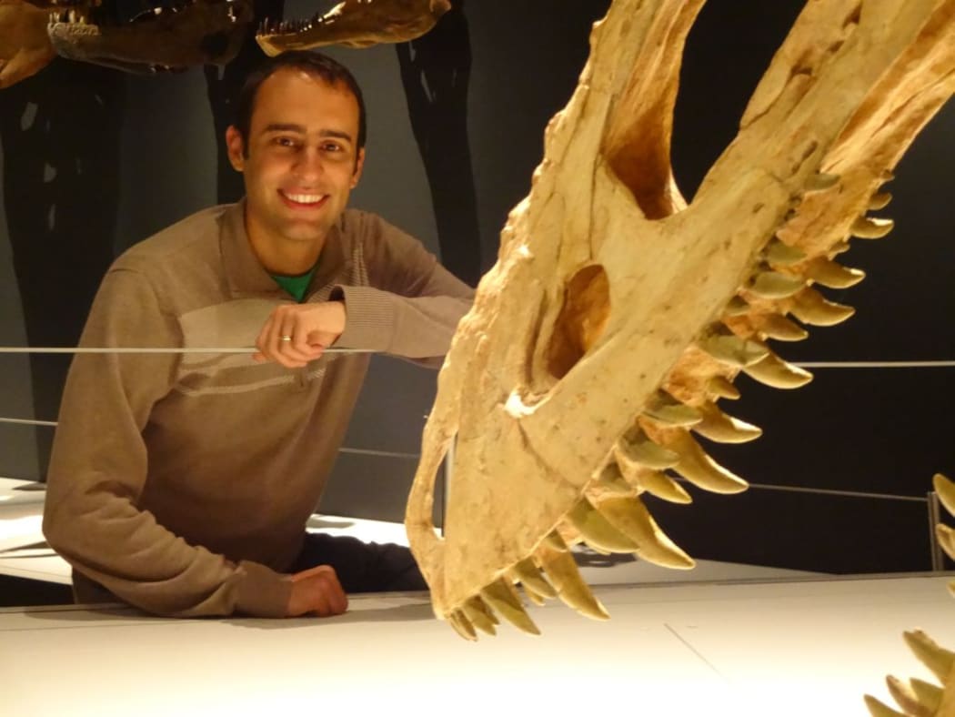 Palaeontologist Stephen Brusatte with a long-nosed tyrannosaur from the Alioramus genus, which is on display in Te Papa's Tyrannosaurs: Meet the Family exhibition.