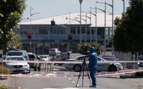 Police gather evidence on Railway Street West after a shooting in Papakura early Saturday morning left one man dead and another seriously injured.