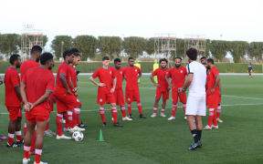 New Caledonia's players listen in during training in Qatar.
