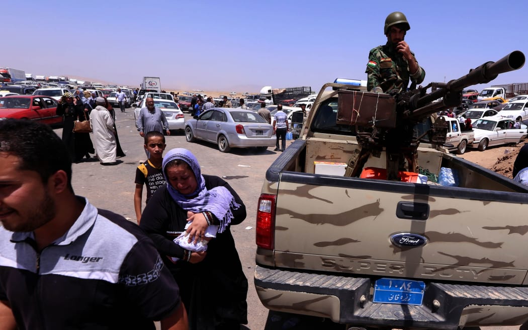 Thousands of Iraqis are fleeing violence in the northern Nineveh province.