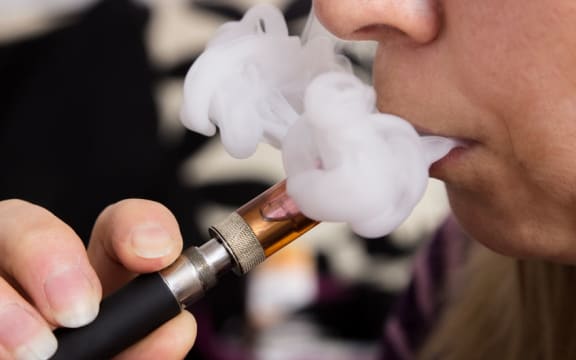 Woman smoking e-cigarette, vaping.