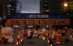 Belgium, Brussels, 2023/02/23. Demonstrators hold a banner reading Bring the stolen children home next to teddy bears and toys during a demonstration organized by the NGO Avaaz near the European institutions ahead of the 1-year anniversary of the Russian invasion of Ukraine. The demonstration is meant to bring to attention the reported claim of abduction of Ukrainian children by Russia.