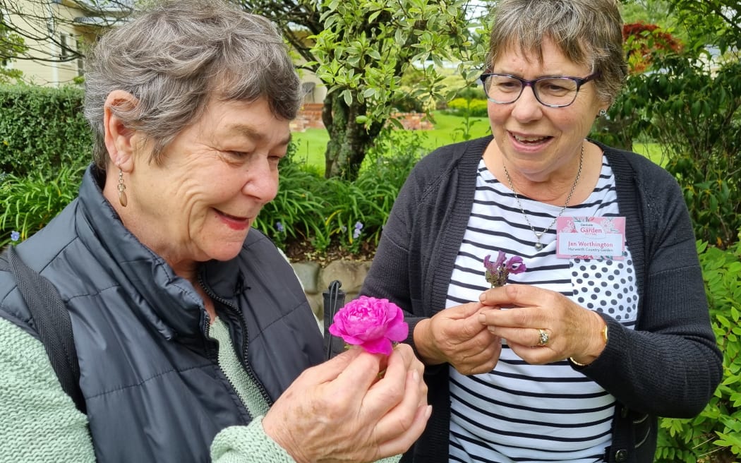 Margaret Kreegher, left, smells flowers from Jan Worthington's Hurworth Country Garden.