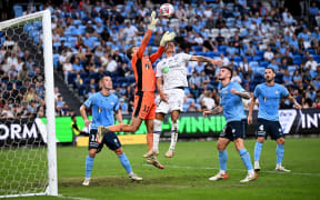 Harrison Devenish-Meares of Sydney and Logan Rogerson of Auckland compete for possession during the A-League Men Round 26 match between Sydney FC and Auckland FC at Allianz Stadium in Sydney.