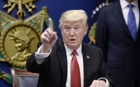 President Donald Trump signs Executive Orders in the Hall of Heroes at the Department of Defense in Virginia.