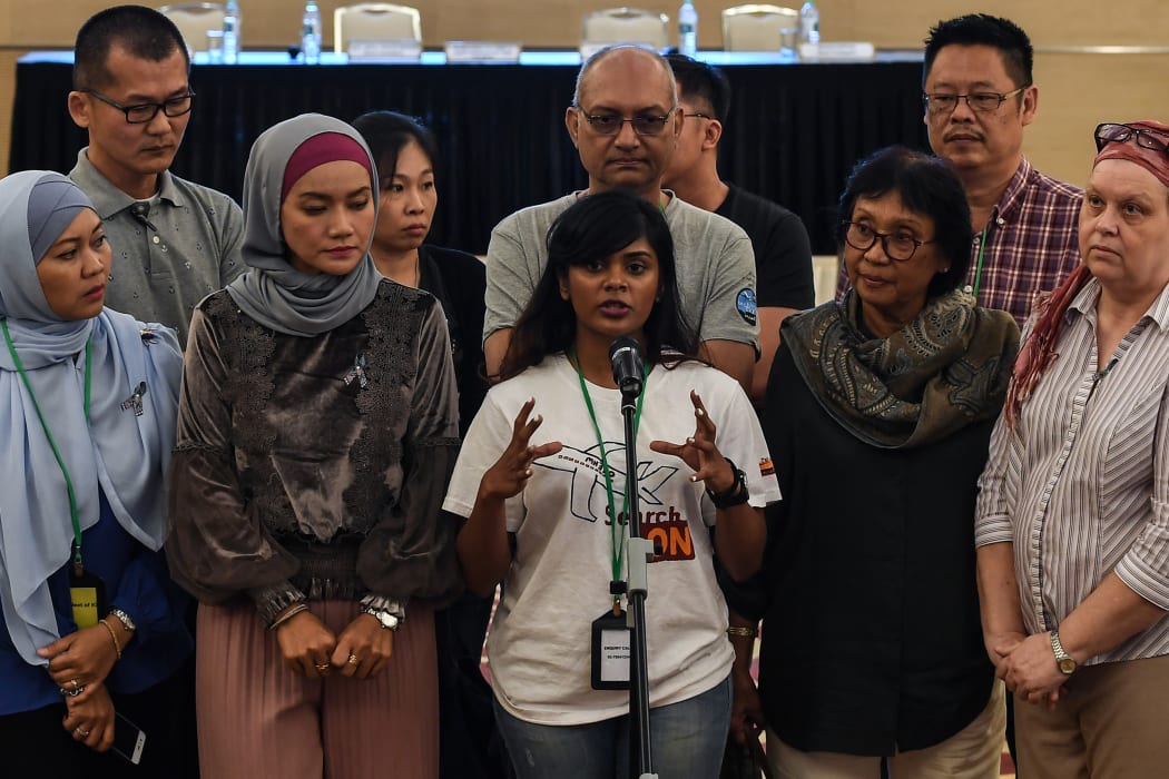 Grace Subathirai Nathan (C), daughter of missing Malaysia Airlines flight MH370 passenger Anne Daisy, speaks during a press conference after being presented with the final investigation report on the missing flight, in Putrajaya, outside Kuala Lumpur, on July 30, 2018.