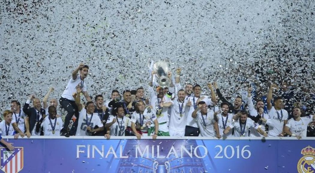Real Madrid's Spanish defender Sergio Ramos lifts the trophy after Real Madrid won the UEFA Champions League final football match over Atletico Madrid.