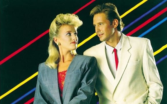 An cropped image of a BNZ poster advertising EFTPOS. Two sharply dressed people lean against the bonnet of an expensive car. The caption reads "the fashionable way to pay."