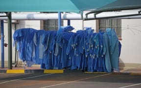 Personal Protective Equipment (PPE) are hung next to tents dedicated to the treatment of possible COVID-19 coronavirus patients at the Tshwane District Hospital in Pretoria, South Africa.
