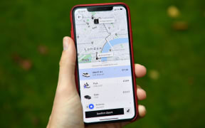 An illustration of Uber ride-hailing app page showing a trip to be taken in central London on November 25, 2019. - London's transport authority today refused to renew an operating licence for ride-hailing giant Uber because of safety and security concerns. (Photo by Daniel LEAL / AFP)