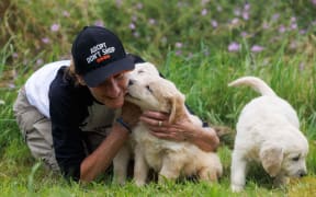 HUHA dog shelter manager Claire Jamieson receives some appreciation from puppies at the shelter